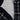 Close-up of the inside lining of a black and gray plaid jacket with fuzzy material.