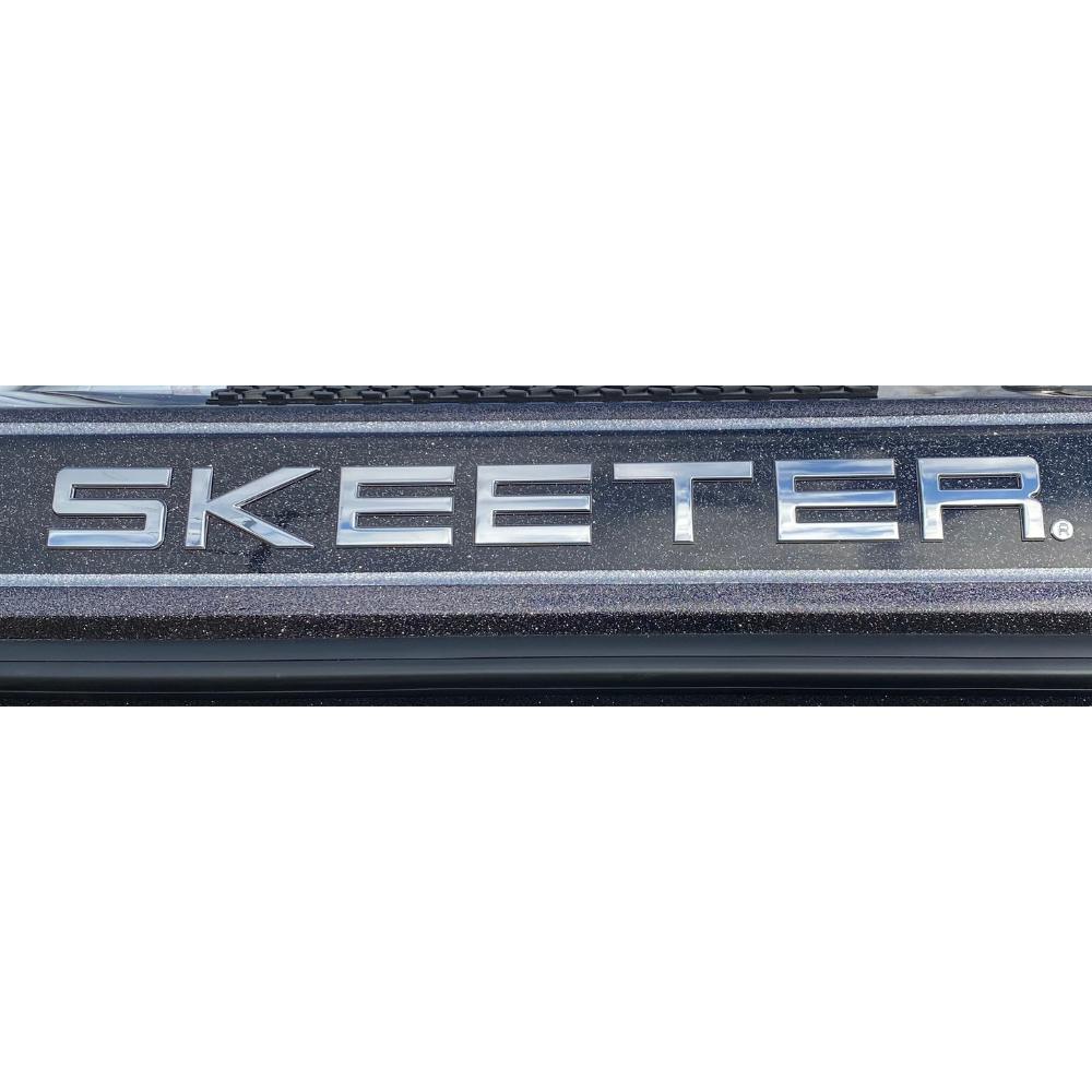 A raised chrome Skeeter decal placed on the side of a boat. 