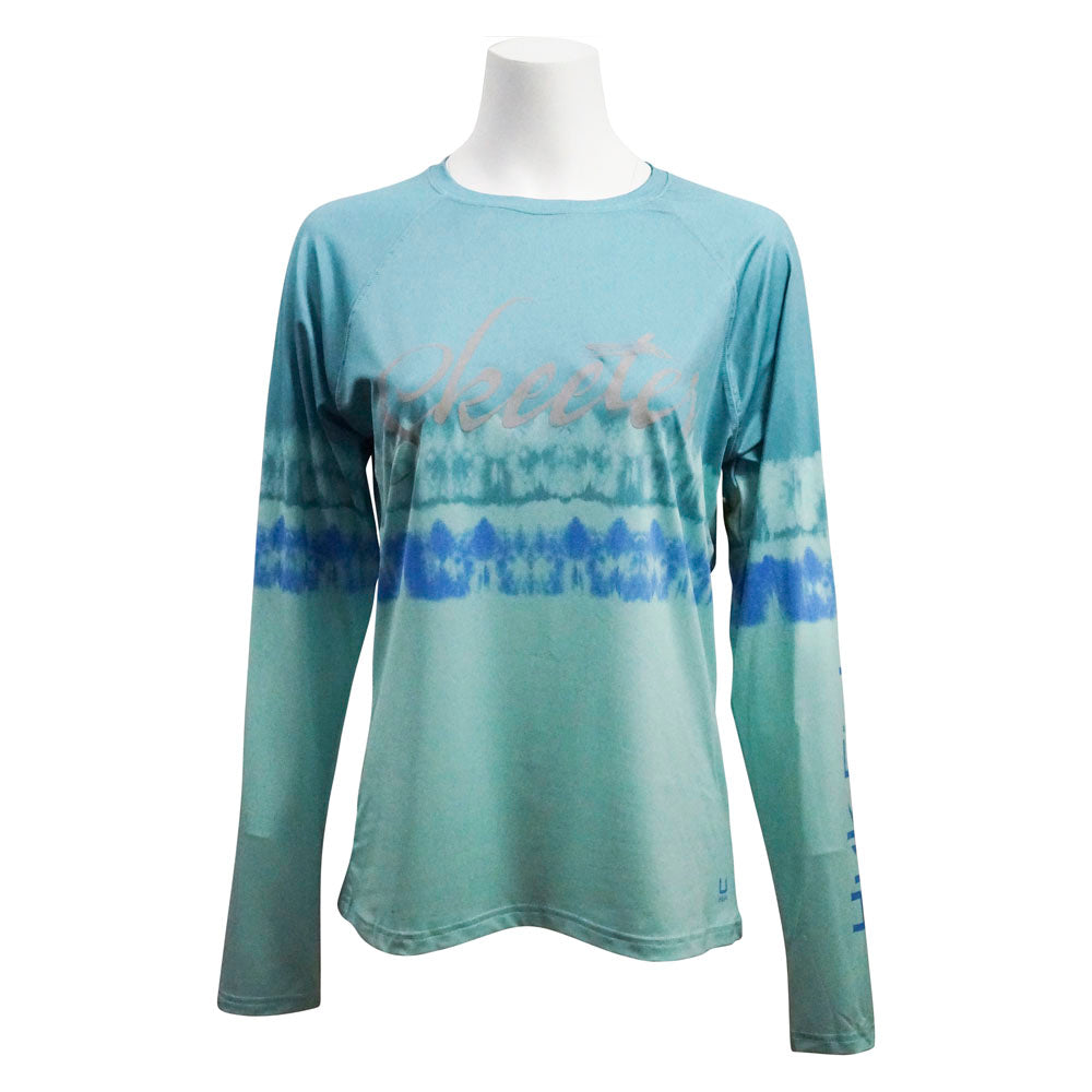 Front of a blue and green water-color striped women's UPF long sleeve with the Skeeter logo printed in grey across the chest. 