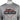 Close up of a gray long-sleeve shirt with a black and red Skeeter Pro Staff logo across the chest.