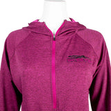 The chest of a ladies UPF hooded half-zip long sleeve in fuchsia pink. Embroidered on the left chest is the skeeter logo in pink and black. 