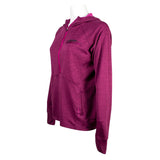 Left side of a ladies UPF hooded half-zip long sleeve in fuchsia pink. Embroidered on the chest is the skeeter logo in pink and black. 